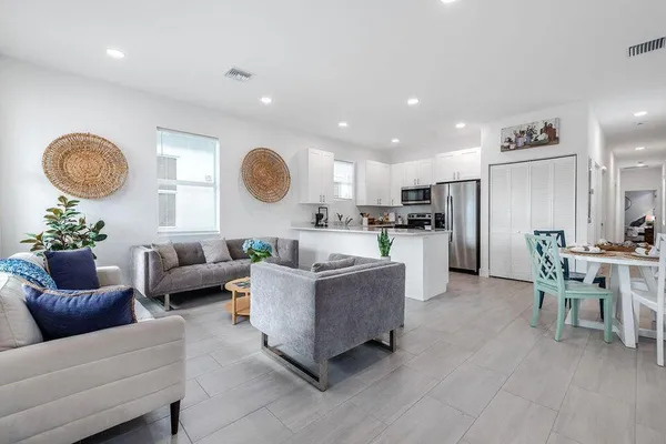 a living room with furniture kitchen and a table
