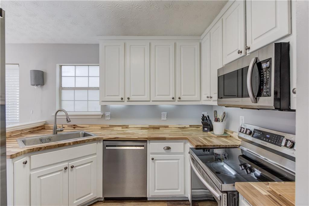 504 Oxford Ridge Winder, GA 30680 - Photo 12 of 30 a kitchen with stainless steel appliances granite countertop a sink stove oven a sink and dishwasher with cabinets