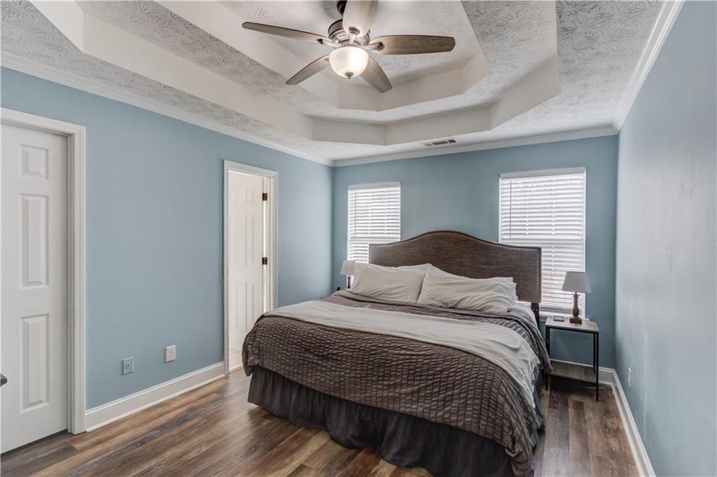 504 Oxford Ridge Winder, GA 30680 - Photo 14 of 30 a bedroom with a bed and a chandelier