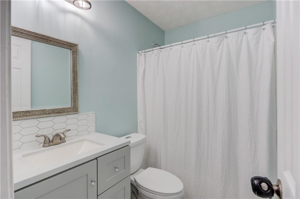 504 Oxford Ridge Winder, GA 30680 - Photo 22 of 30 a bathroom with a sink vanity mirror and toilet