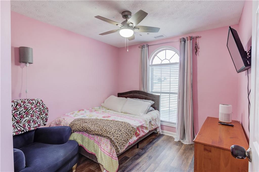 504 Oxford Ridge Winder, GA 30680 - Photo 23 of 30 a bedroom with a bed and a chandelier