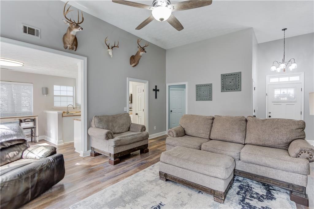 504 Oxford Ridge Winder, GA 30680 - Photo 8 of 30 a living room with furniture and a chandelier
