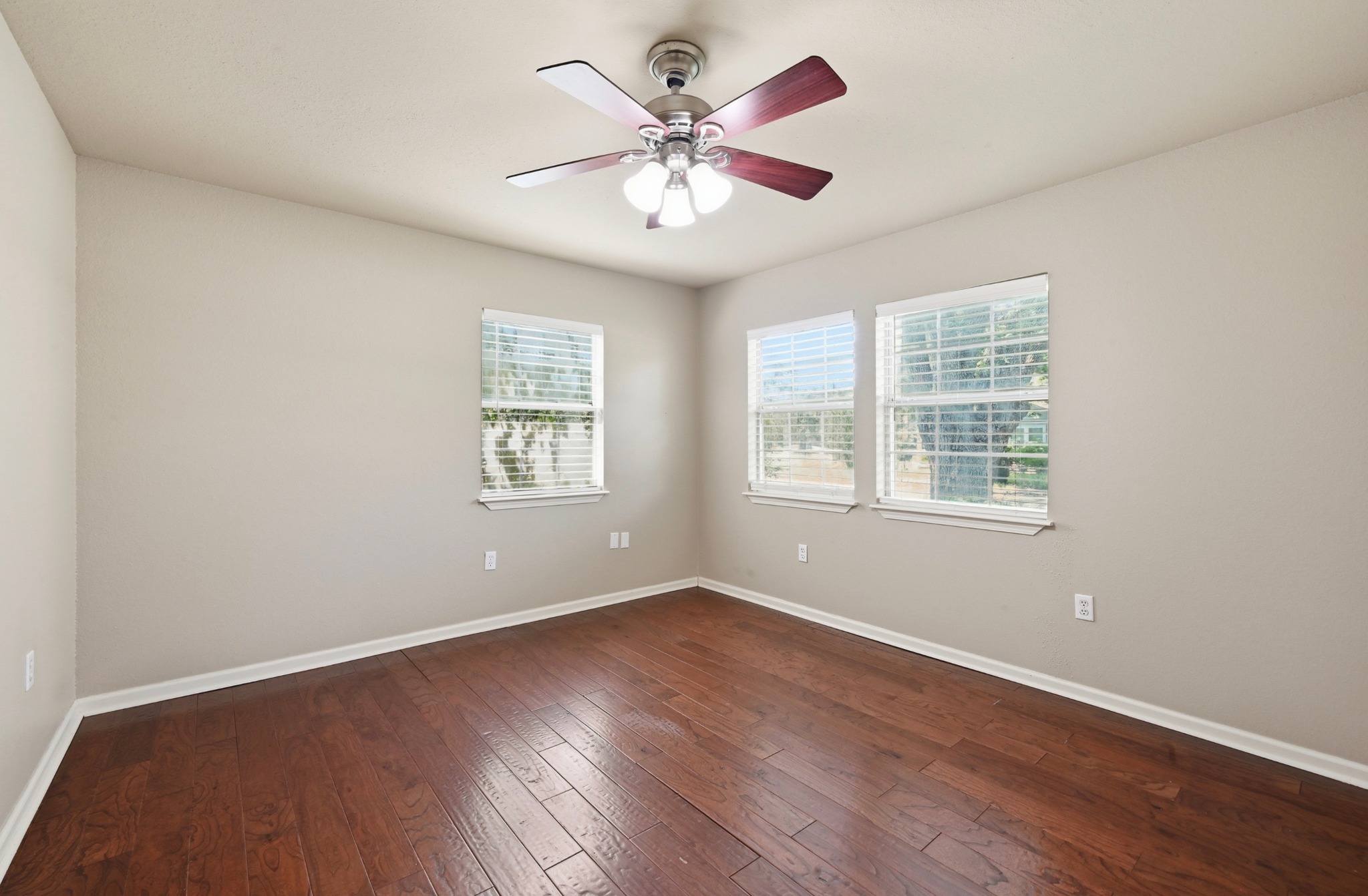1127 Parr Street Luling, TX 78648 - Photo 10 of 20 Rich hardwood flooring complements ample window light, creating an inviting personal space.