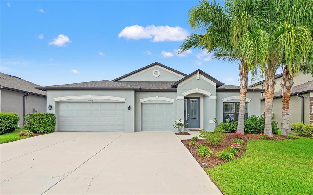 a front view of a house with a garden and entryway