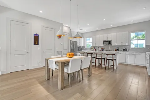 a large kitchen with a table and chairs