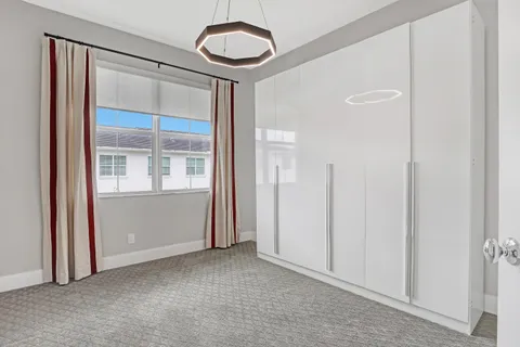 a view of a room with an empty space and wooden floor