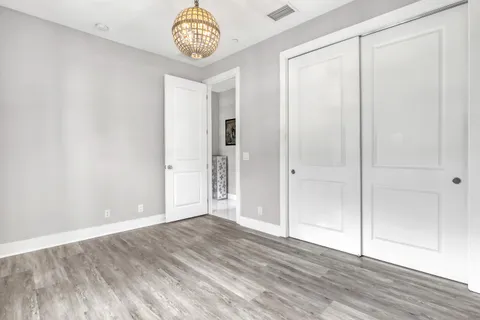 a view of an empty room and wooden floor
