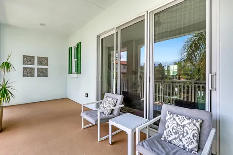 a balcony with furniture and a potted plant