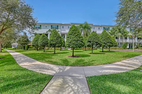 a view of a big building with a big yard and plants