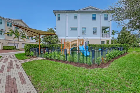 a front view of a house with a garden and plants
