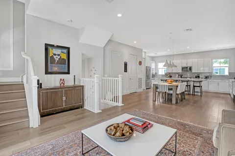 a living room with furniture and view of kitchen