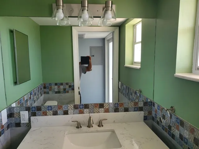 a kitchen with a sink and stainless steel appliances