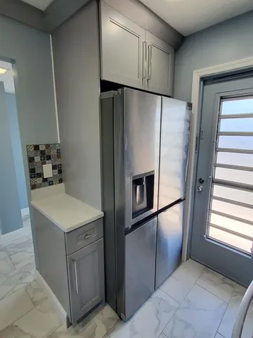 a view of a kitchen with a sink and cabinets