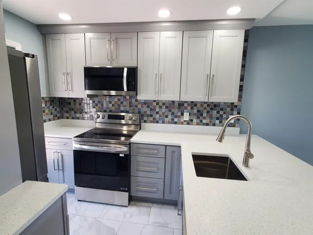 a kitchen with a stove and a microwave