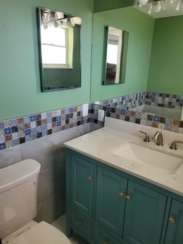 a kitchen with granite countertop a refrigerator and a sink