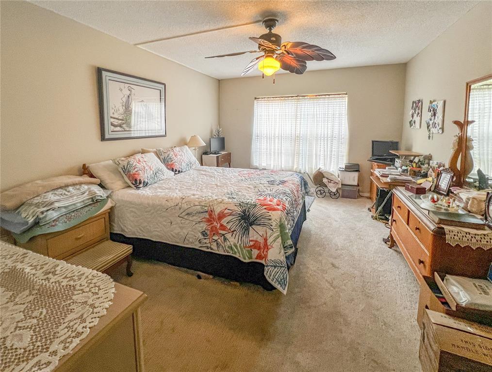 10350 Imperial Point Drive West, Unit 4 Largo, FL 33774 - Photo 14 of 68 a bedroom with a bed and a couch