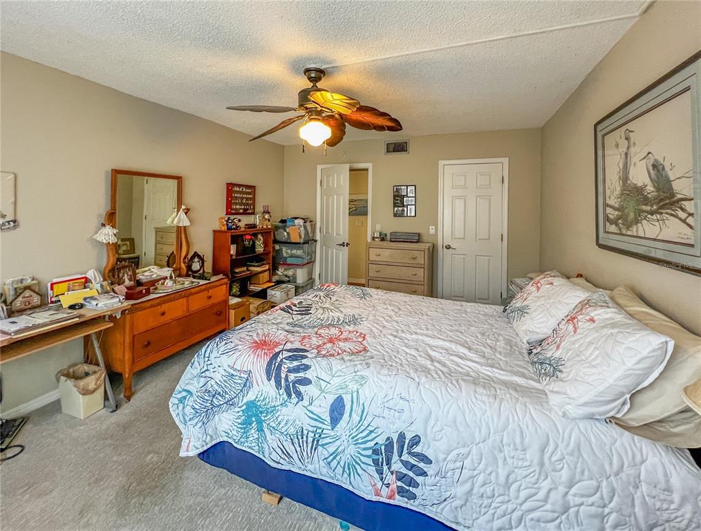 10350 Imperial Point Drive West, Unit 4 Largo, FL 33774 - Photo 15 of 68 a bedroom with bed and a chandelier