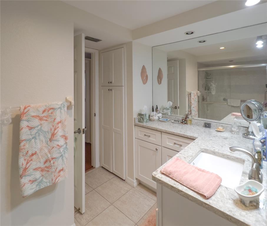 10350 Imperial Point Drive West, Unit 4 Largo, FL 33774 - Photo 18 of 68 a bathroom with a sink a vanity and a mirror