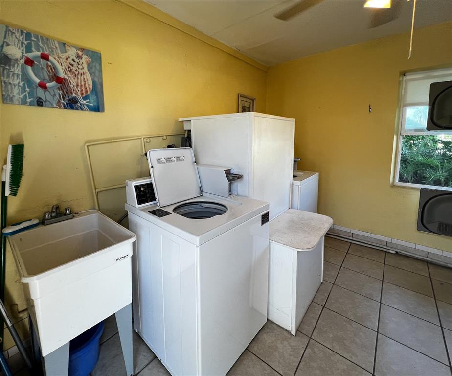 10350 Imperial Point Drive West, Unit 4 Largo, FL 33774 - Photo 25 of 68 a bathroom with a sink and a washer dryer
