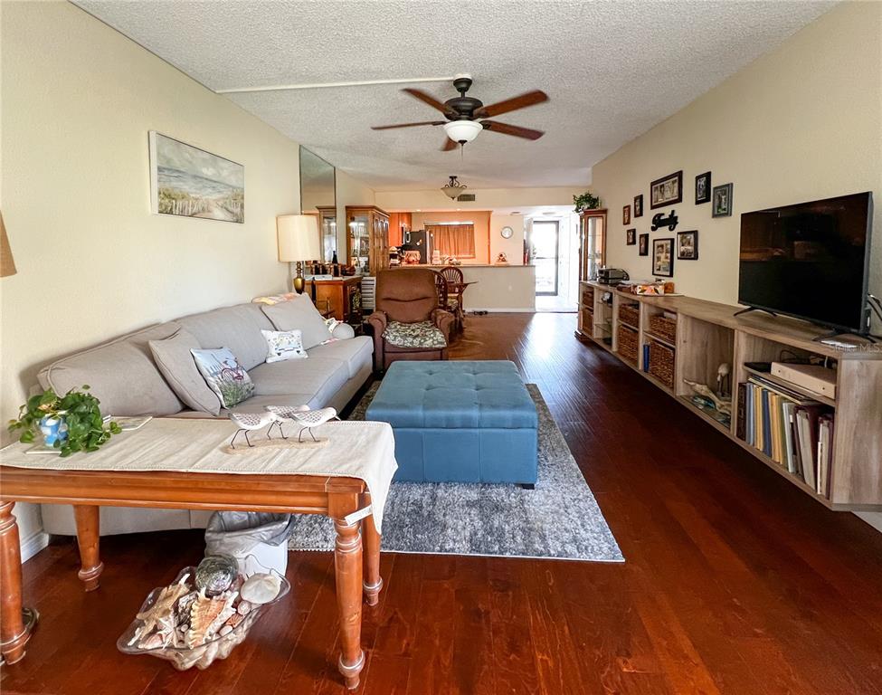 10350 Imperial Point Drive West, Unit 4 Largo, FL 33774 - Photo 4 of 68 a living room with furniture and a flat screen tv