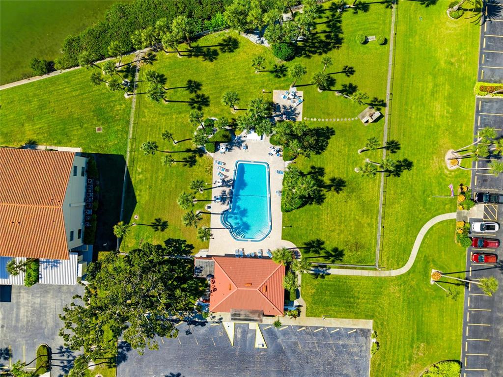 10350 Imperial Point Drive West, Unit 4 Largo, FL 33774 - Photo 49 of 68 an aerial view of a swimming pool with a yard