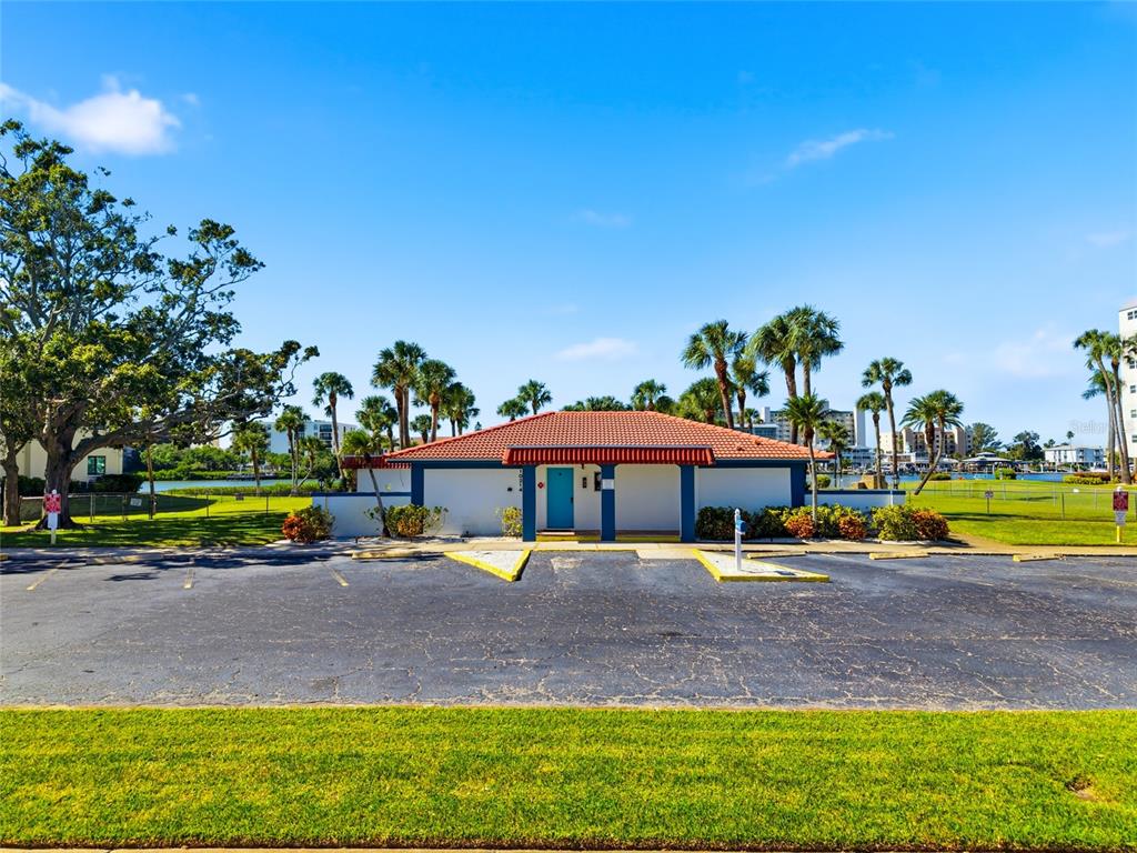 10350 Imperial Point Drive West, Unit 4 Largo, FL 33774 - Photo 64 of 68 a view of a swimming pool with lawn chairs under an umbrella