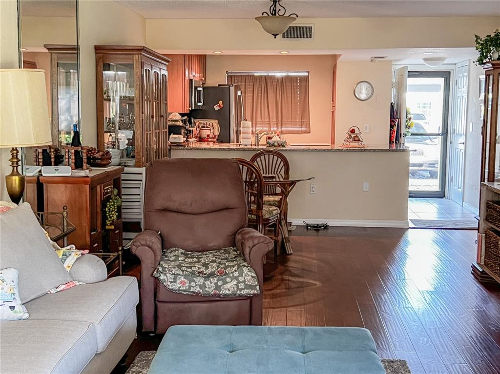 10350 Imperial Point Drive West, Unit 4 Largo, FL 33774 - Photo 8 of 68 a living room with furniture and wooden floor