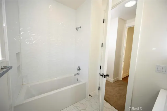 a kitchen with a refrigerator a stove a sink and a window