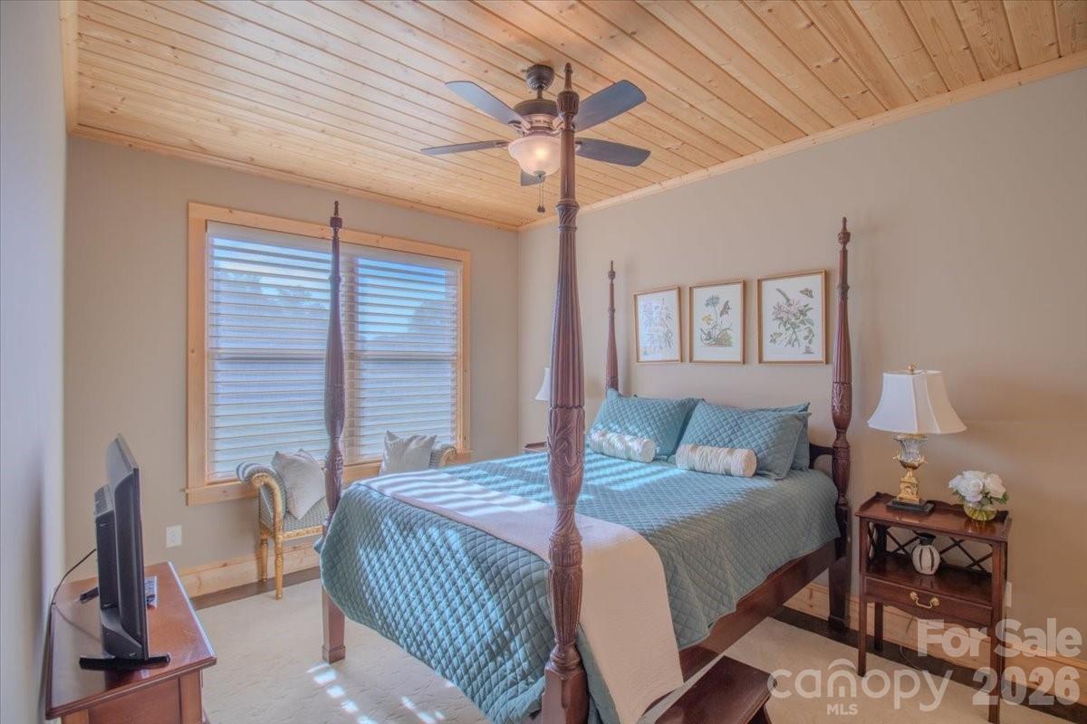 1083 Union Community Road Thurmond, NC 28683 - Photo 19 of 47 a bedroom with a bed and a chandelier