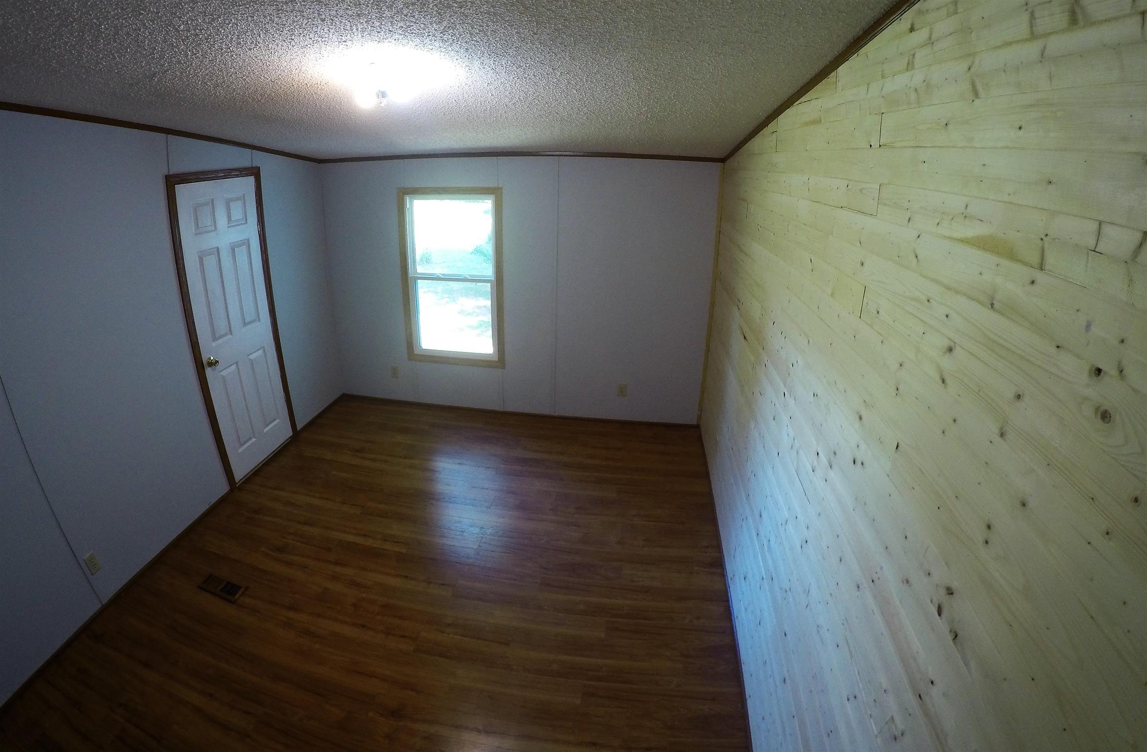 4012 Green Road Springfield, TN 37172 - Photo 13 of 17 an empty room with wooden floor and windows