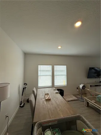 a room with a bed and windows