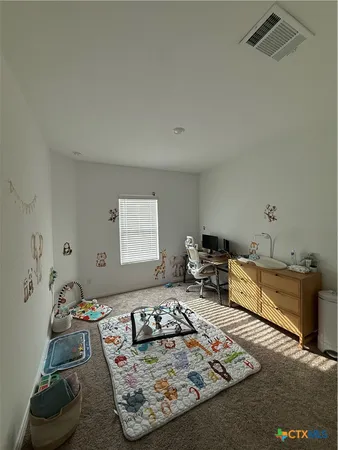 a living room with furniture rug and a table