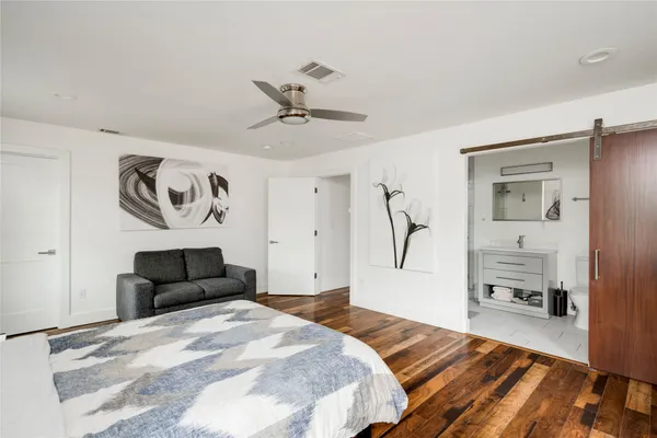 a bedroom with a bed and wooden floor