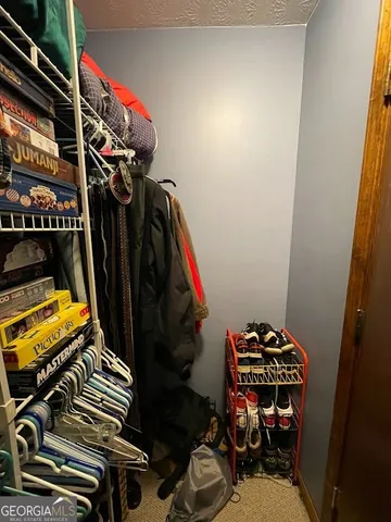 a view of walk in closet with clothes