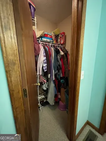 a bedroom with a bed and cabinets