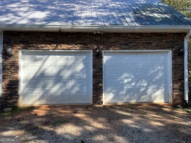 a kitchen with stainless steel appliances granite countertop a sink a stove and a wooden floors