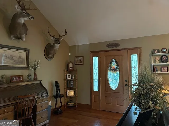 a view of a livingroom with furniture and a mirror