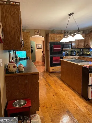 a view of a dining room with furniture and chandelier