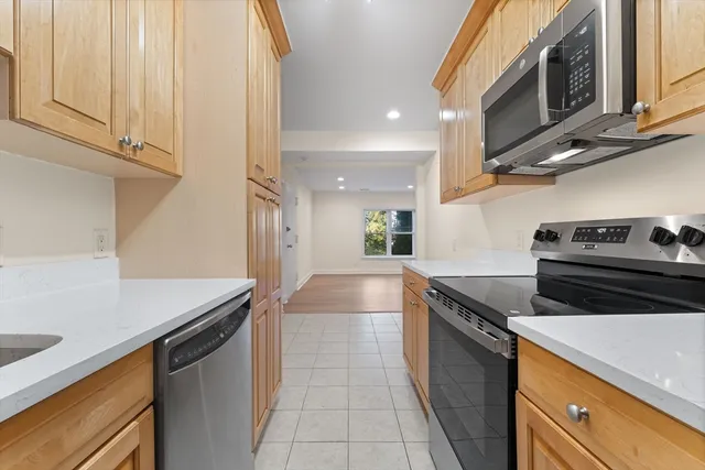 a kitchen with stainless steel appliances granite countertop a sink and a stove