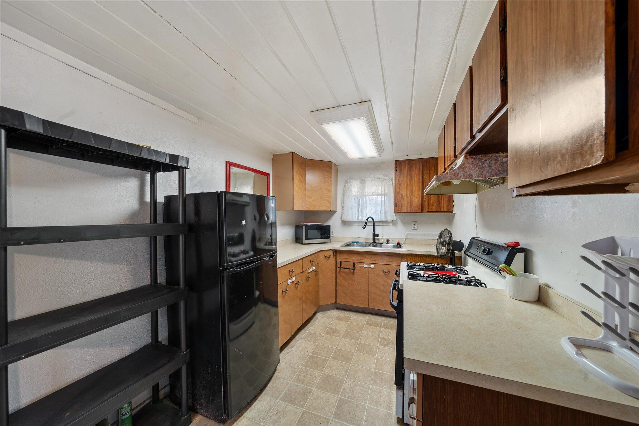 21722 3rd Street Burney, CA 96013 - Photo 11 of 33 a kitchen with stainless steel appliances granite countertop a refrigerator stove and sink