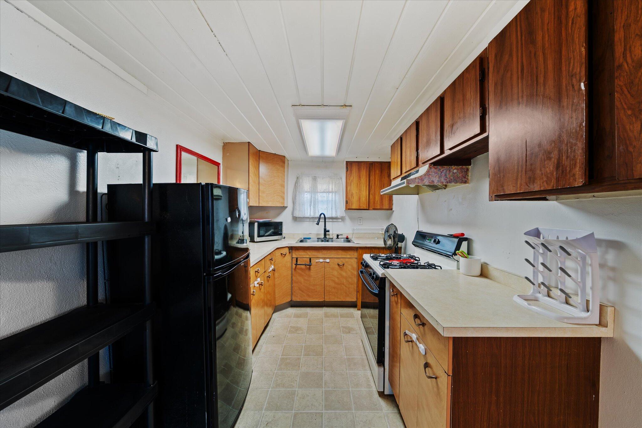 21722 3rd Street Burney, CA 96013 - Photo 12 of 33 a kitchen that has a sink a refrigerator and a stove top oven
