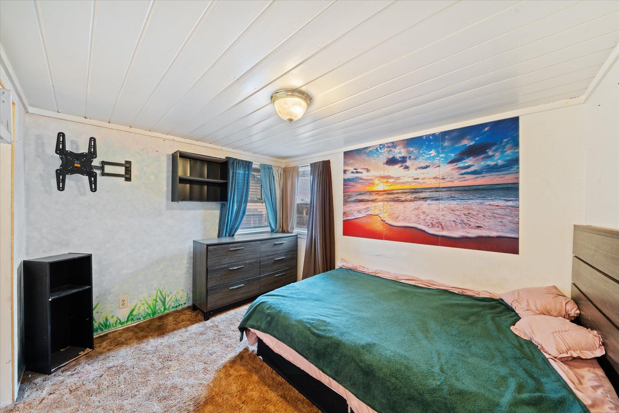 21722 3rd Street Burney, CA 96013 - Photo 14 of 33 a bedroom with a bed and a flat screen tv