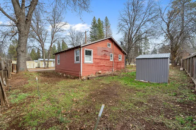 a view of a backyard with wooden fence