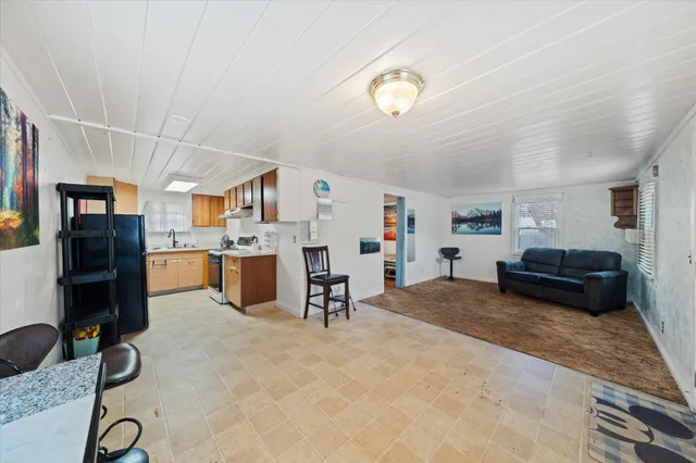 a living room with furniture and kitchen view