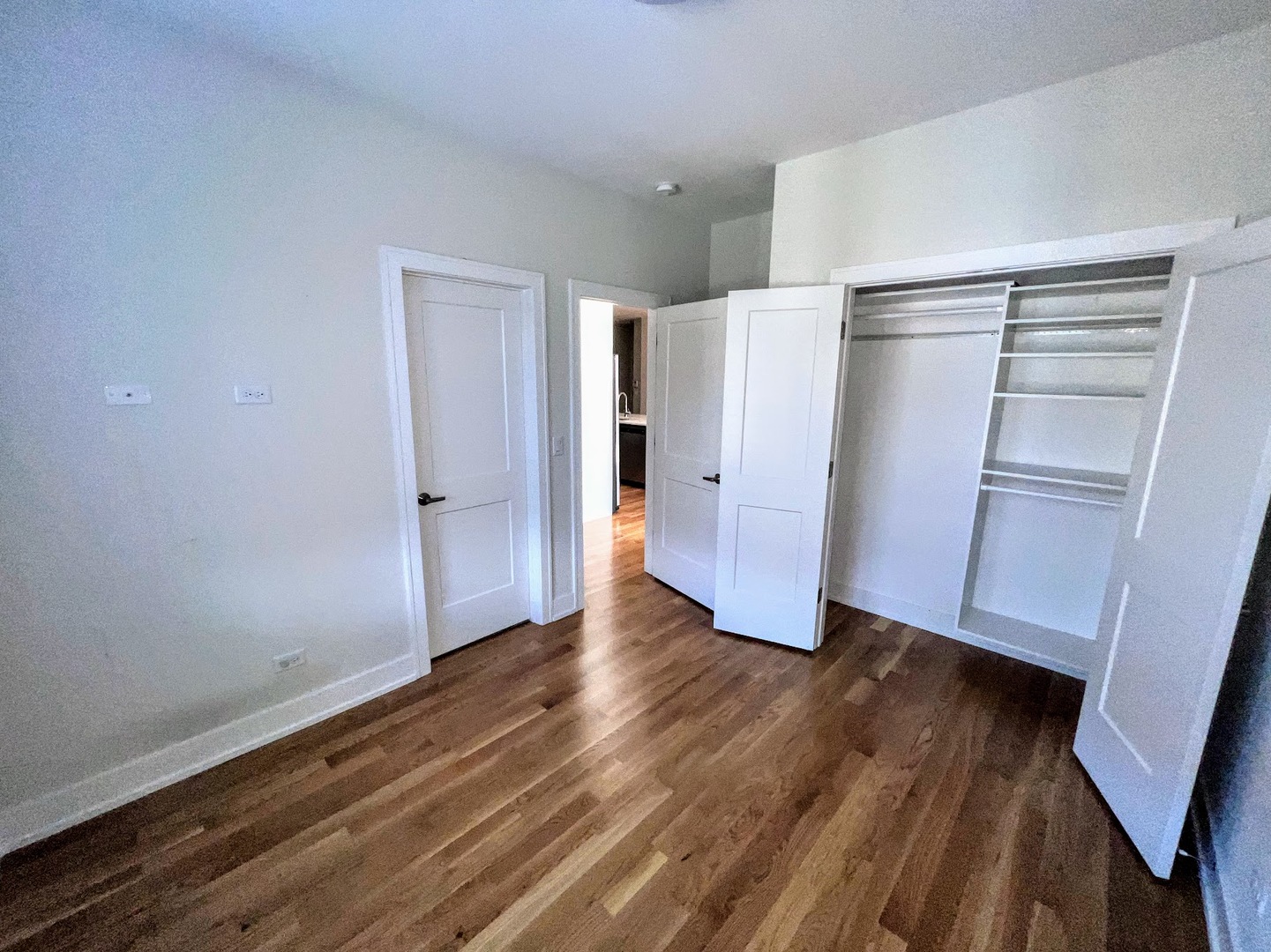3203 North Ridgeway Avenue, Unit 3C Chicago, IL 60618 - Photo 11 of 17 a view of an empty room with wooden floor and a window