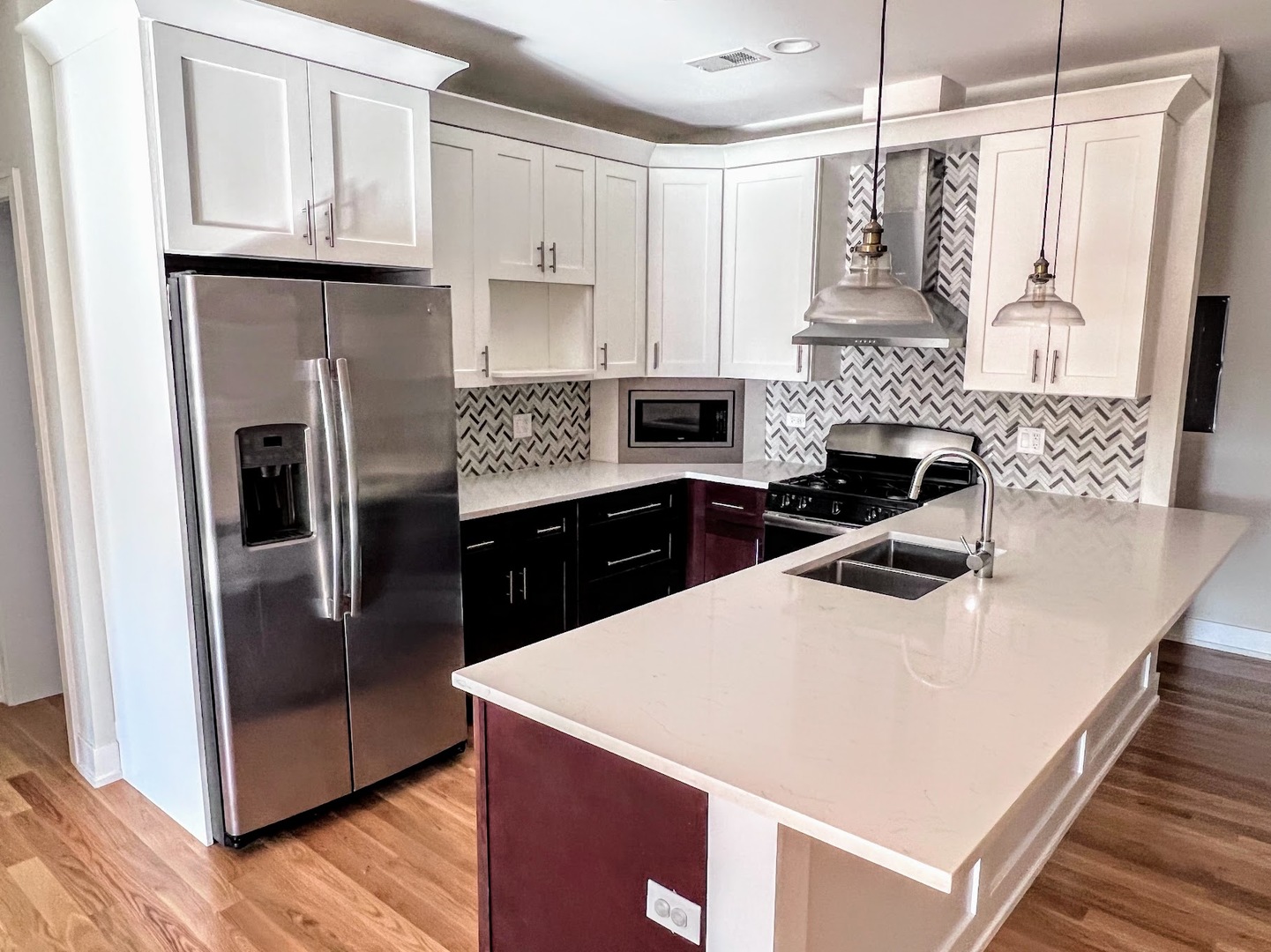 3203 North Ridgeway Avenue, Unit 3C Chicago, IL 60618 - Photo 5 of 17 a kitchen with white cabinets and stainless steel appliances