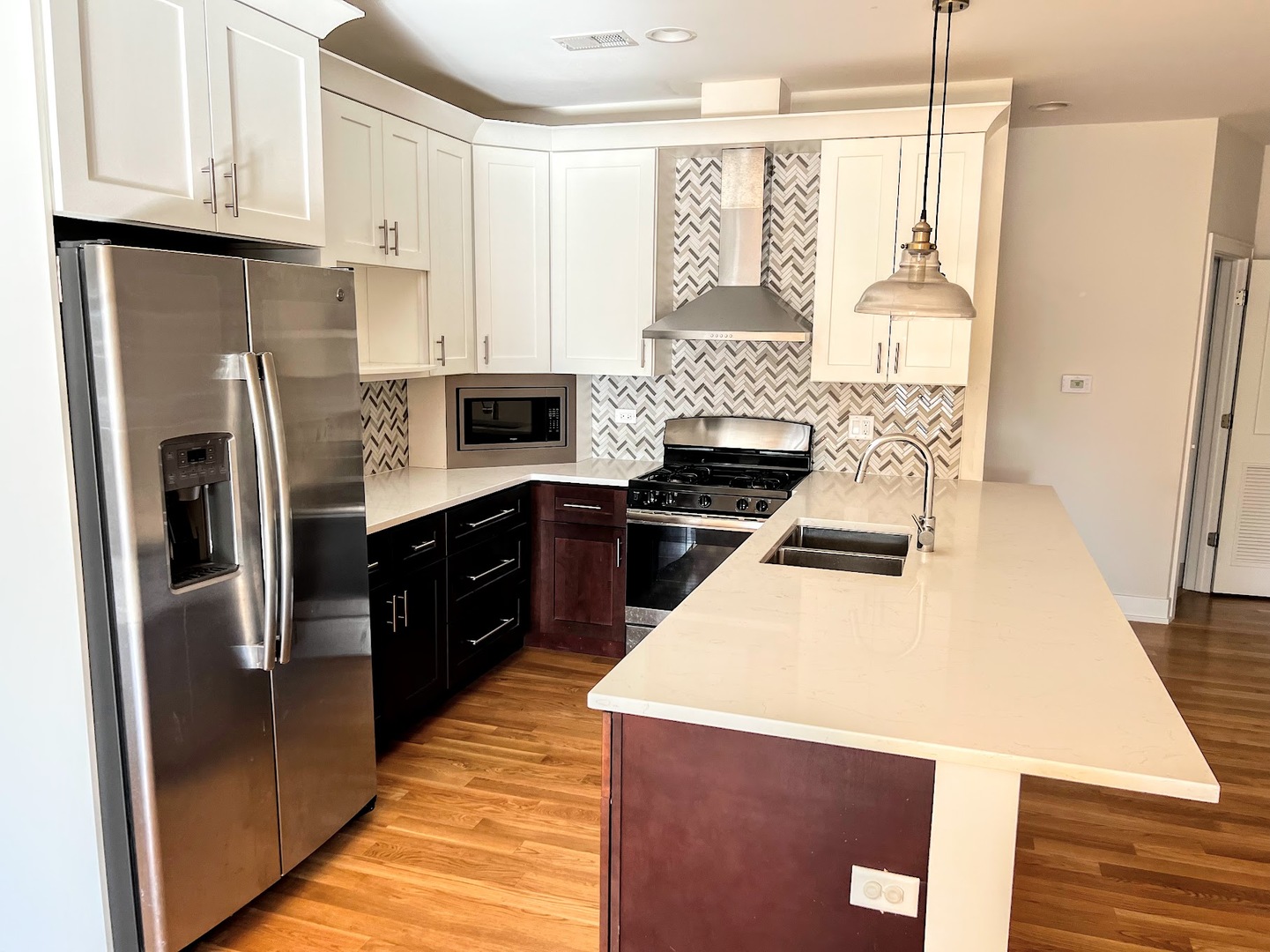 3203 North Ridgeway Avenue, Unit 3C Chicago, IL 60618 - Photo 7 of 17 a kitchen with a refrigerator a stove top oven and white cabinets
