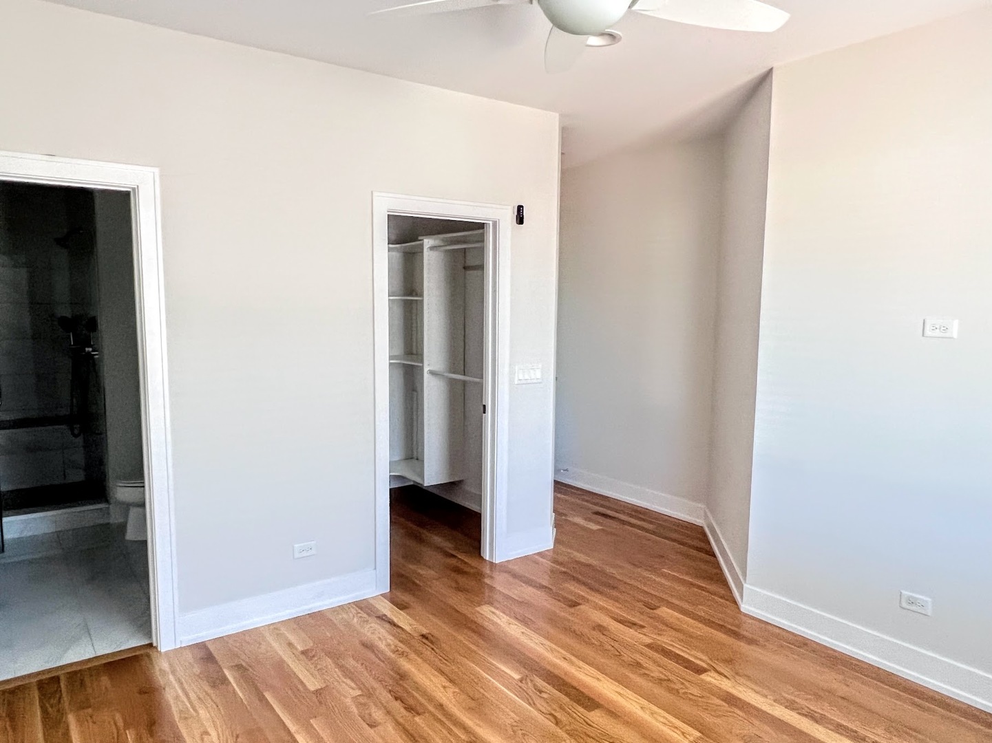 3203 North Ridgeway Avenue, Unit 3C Chicago, IL 60618 - Photo 9 of 17 a view of an empty room with wooden floor and closet