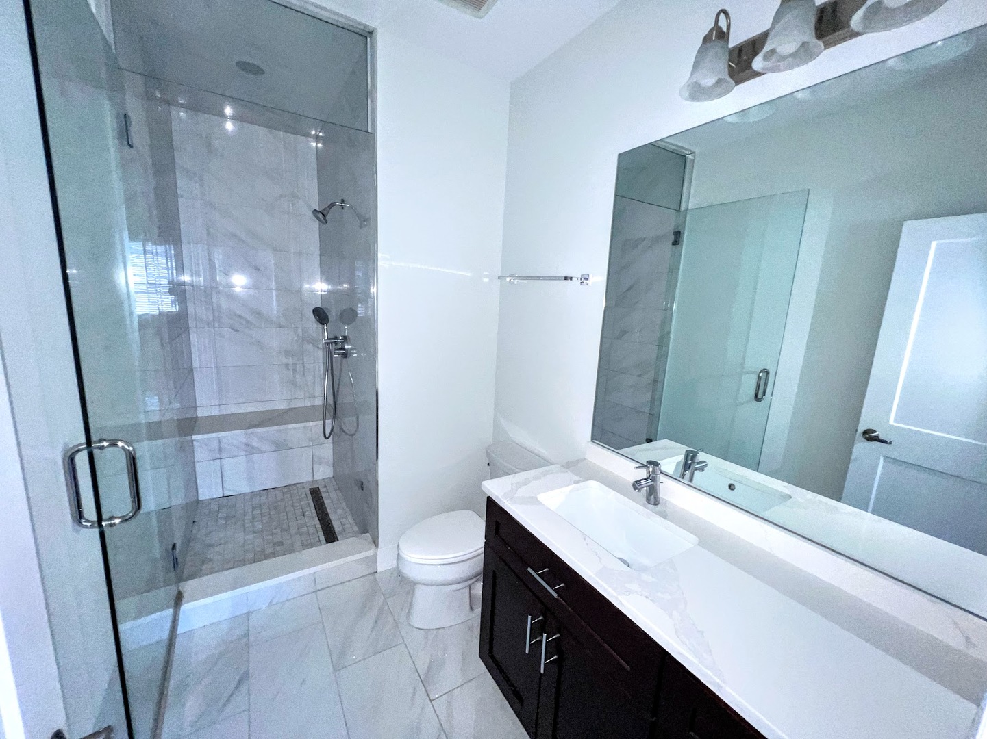 3203 North Ridgeway Avenue, Unit 3C Chicago, IL 60618 - Photo 10 of 17 a bathroom with a double vanity sink toilet and shower