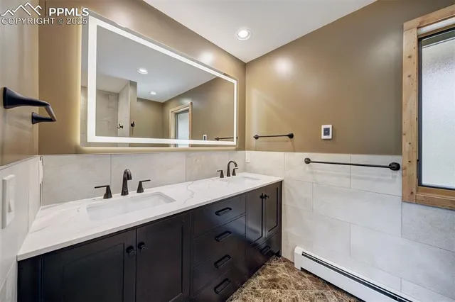 a bathroom with a double vanity sink and a mirror